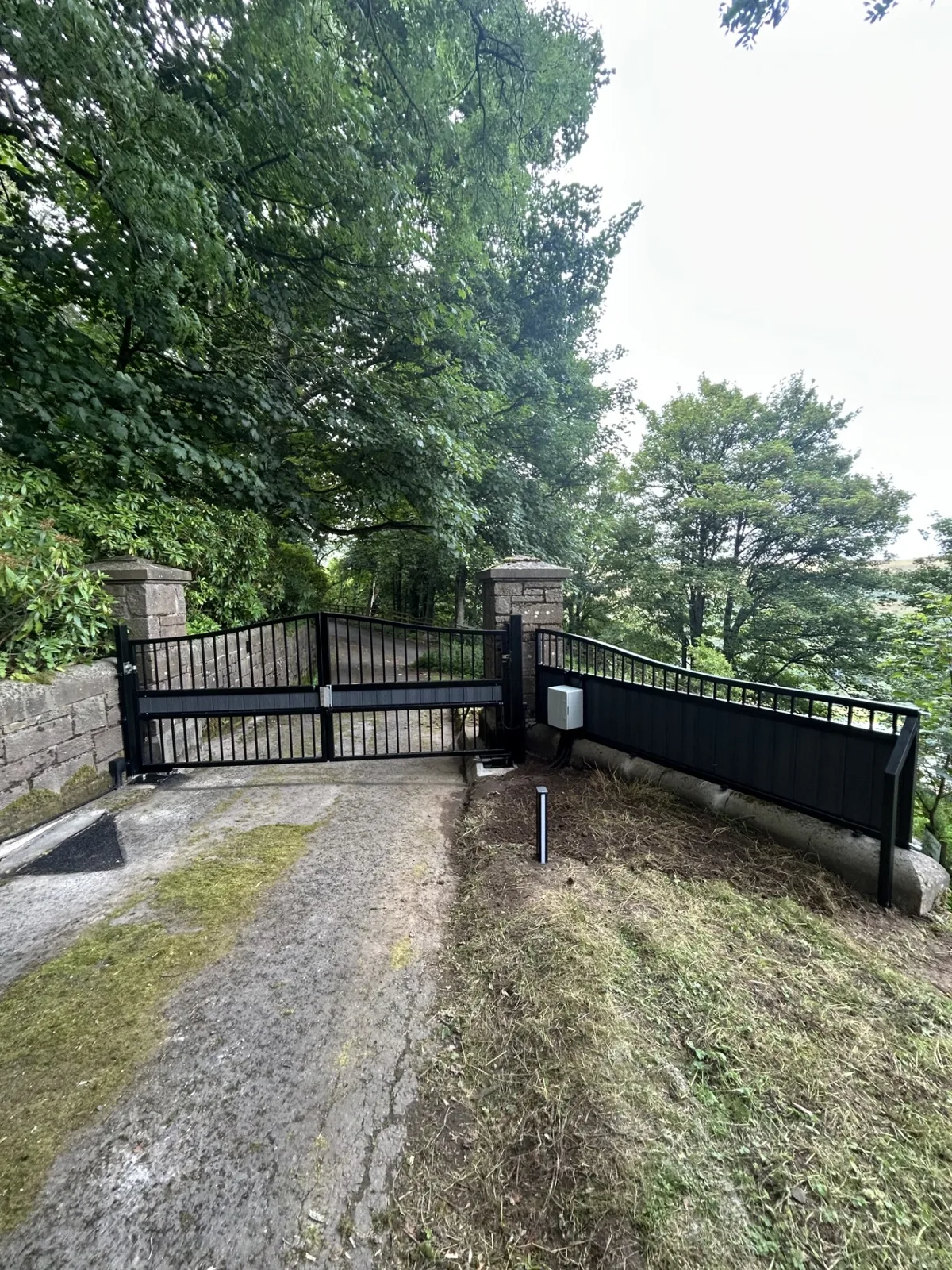 Closed automated entrance with KEY Automation Closed black automated entrance gates with KEY Automation system by KLR Design Limited