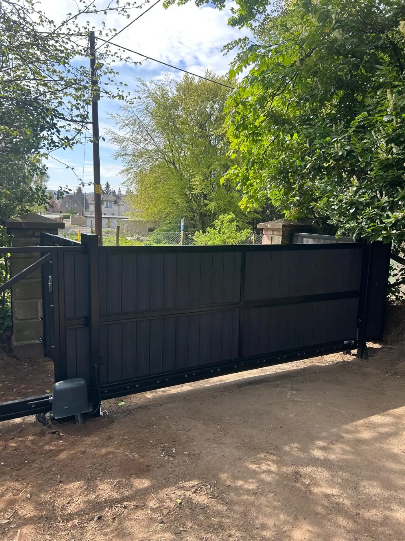 Finished black composite cantilever sliding gate installation in Coupar Angus by KLR Design
