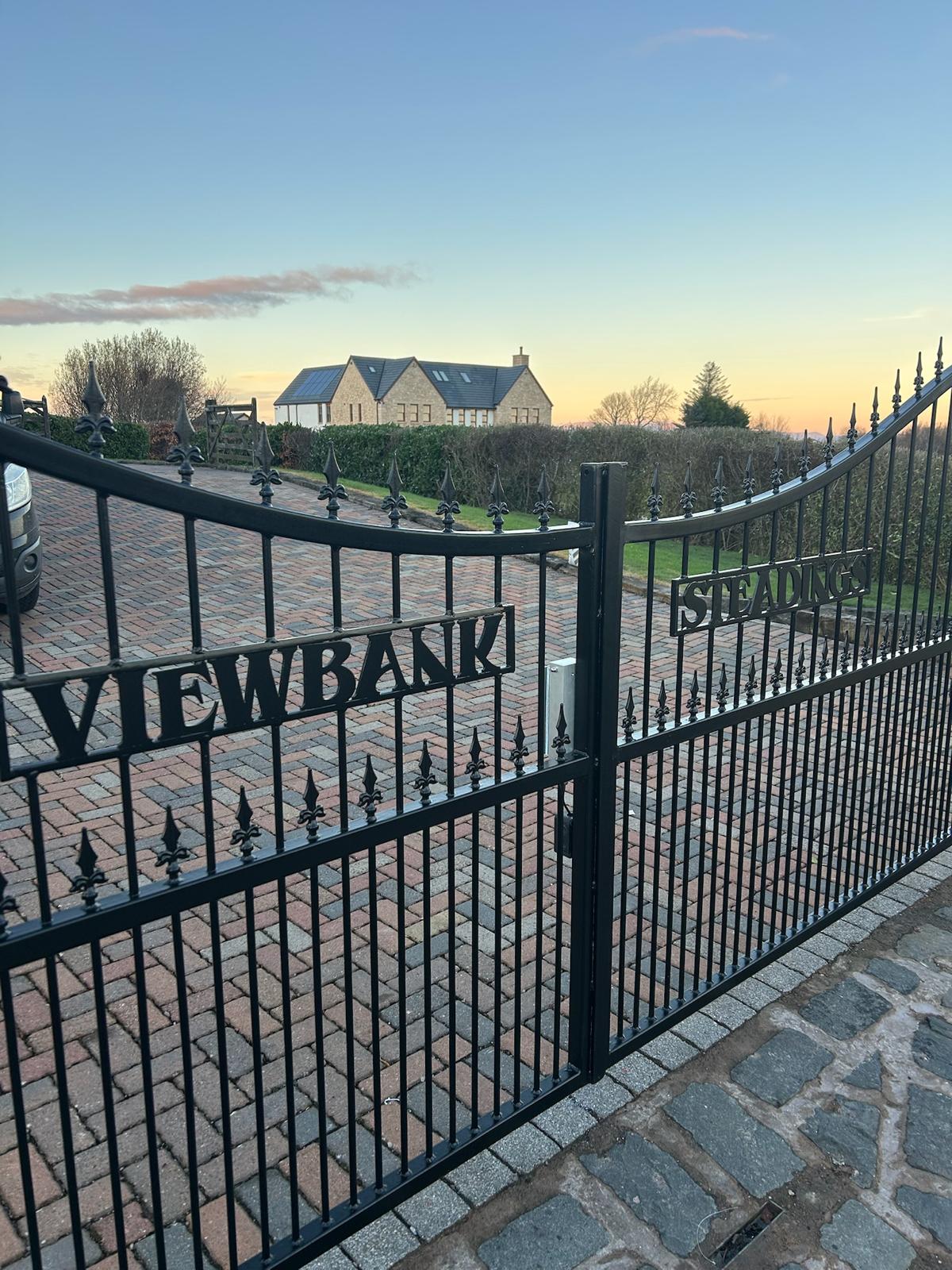 Bespoke wrought iron swing gates with VIEWBANK & STEADINGS laser-cut lettering, fabricated by KLR Design — Scotland
