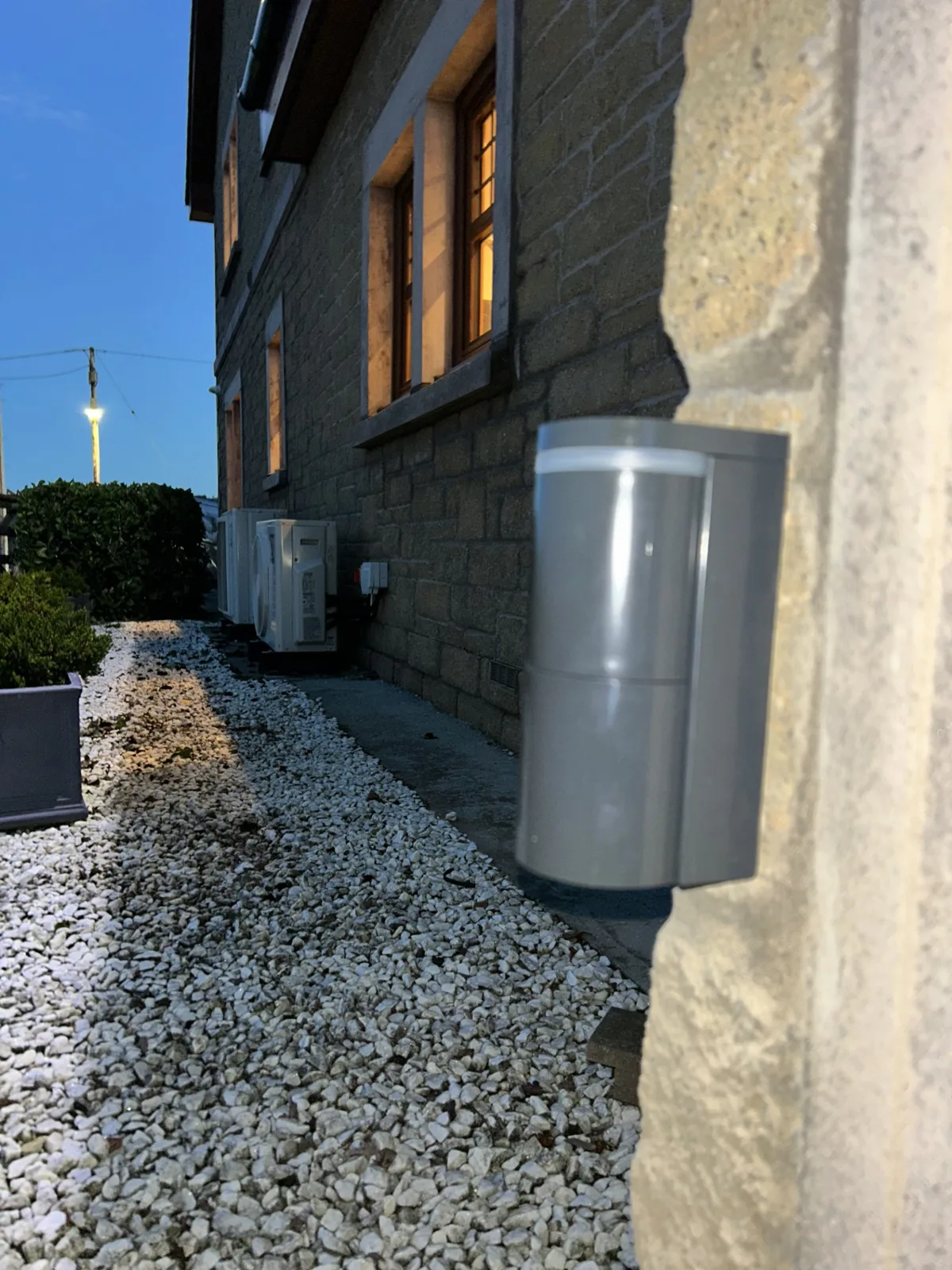 Optex vehicle detector mounted on a stone wall at dusk as part of an automated gate system by KLR Design Limited