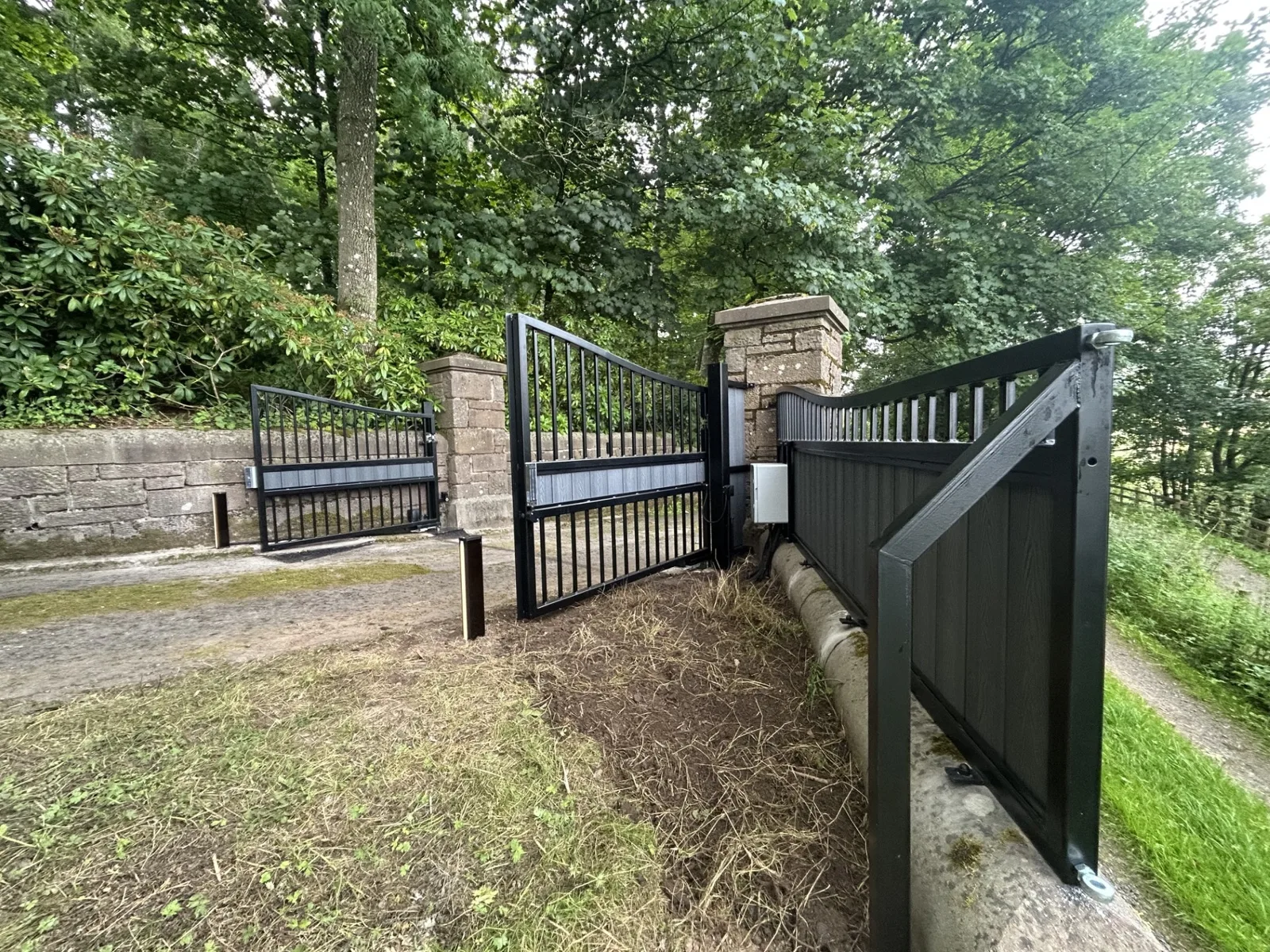 Black automated driveway gates with KEY Automation control equipment and keypad access by KLR Design Limited