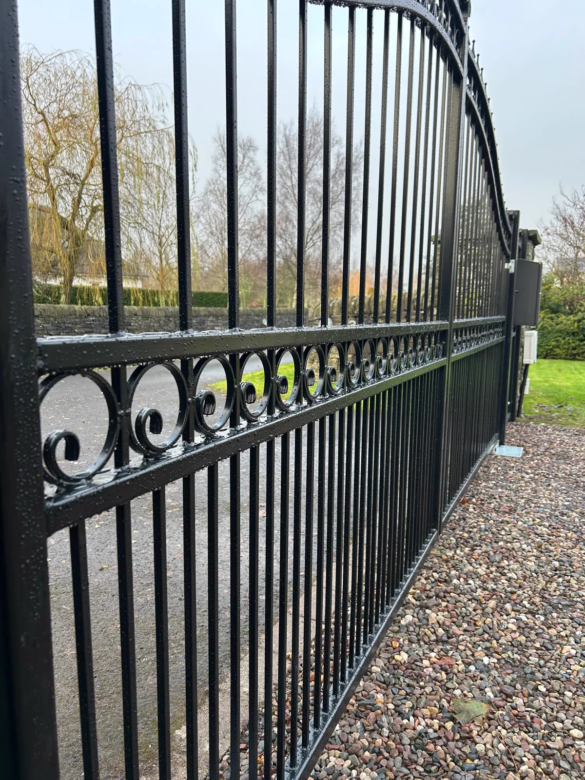 Wrought iron automated gate with scrollwork detail installed by KLR Design Limited