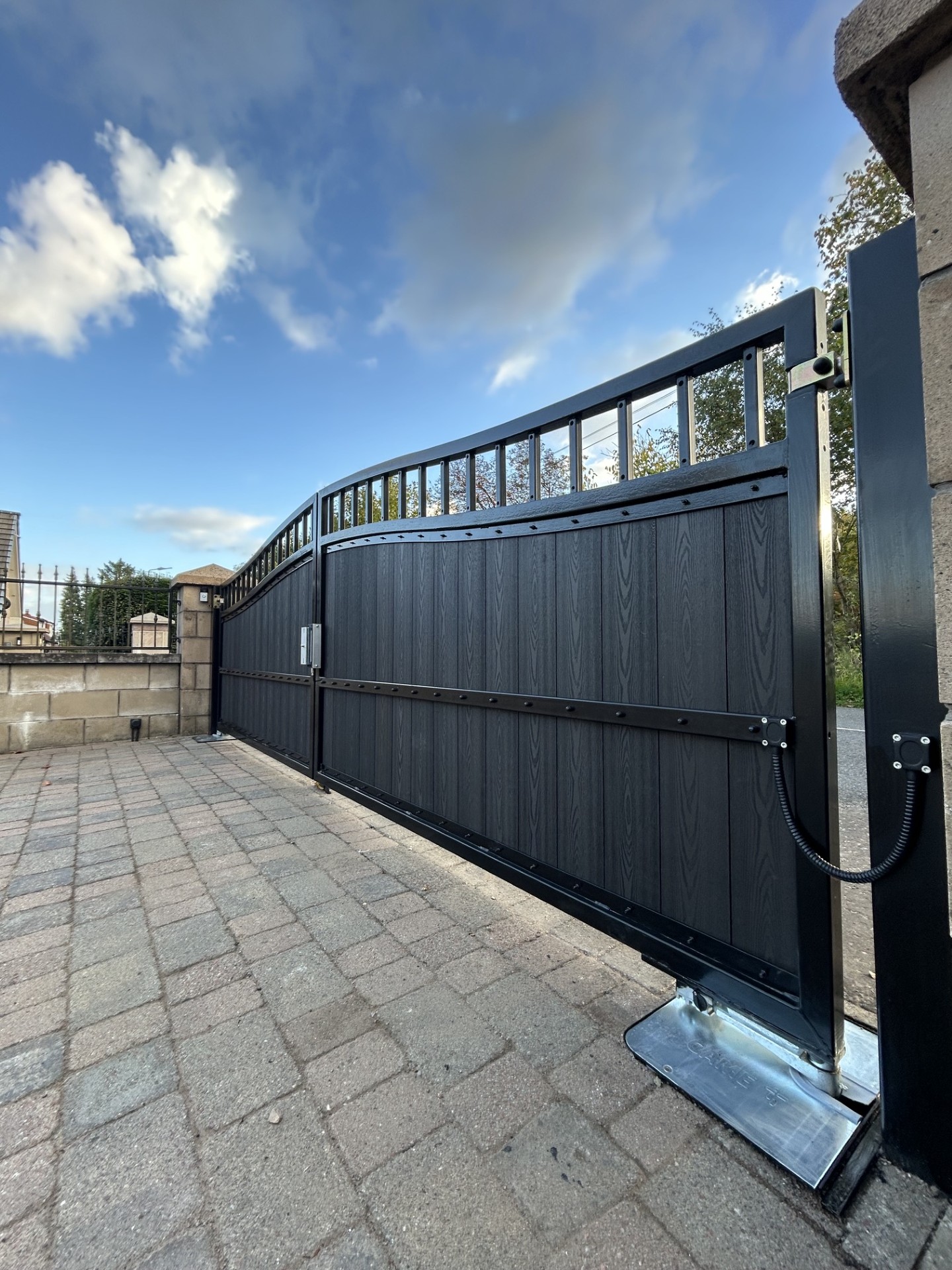 Black composite double swing gates with CAME automation and underground motor by KLR Design Limited
