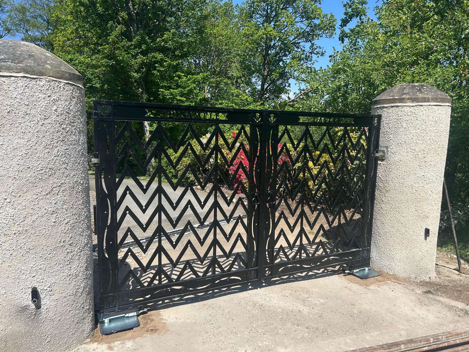 Bespoke laser-cut chevron-pattern electric swing gates at Edinample Castle, Lochearnhead — installed by KLR Design Limited