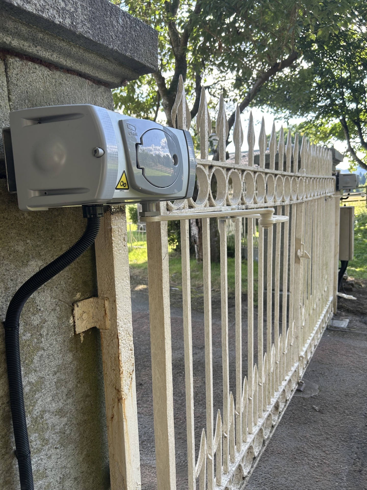 CAME above-ground gate motor mounted on a stone pillar by KLR Design Limited