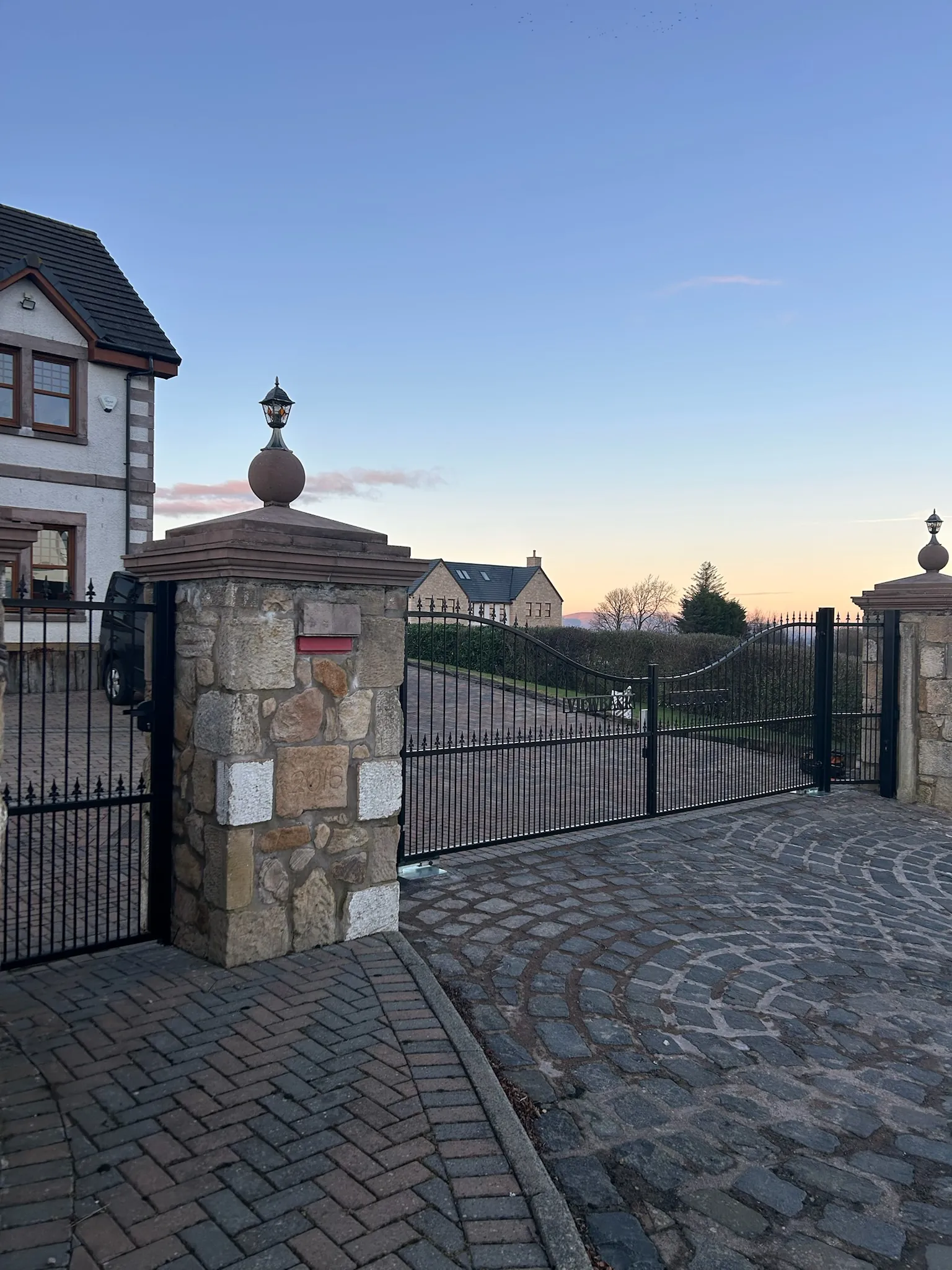 Bespoke wrought iron driveway gates with fleur-de-lis finials in Tayside by KLR Design Limited